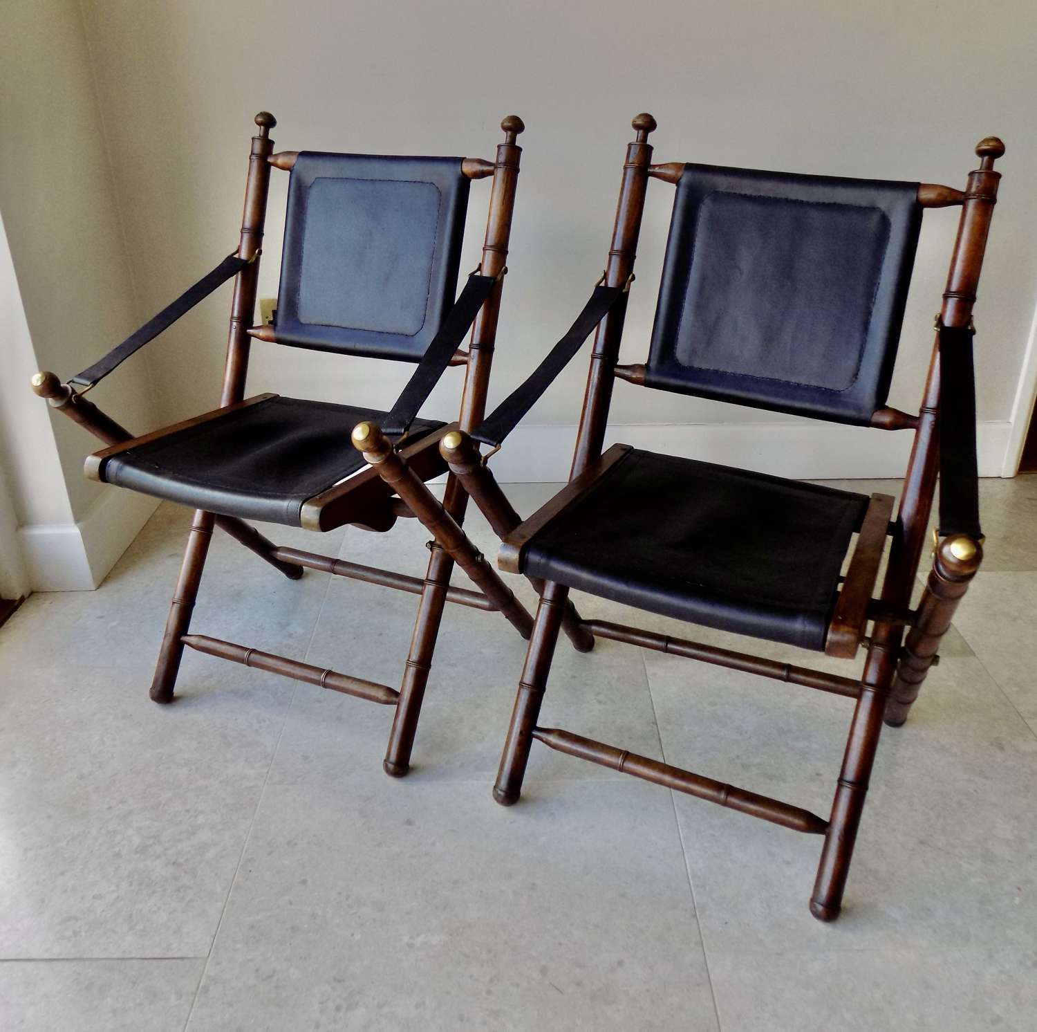 Pair of Campaign style foldable chairs.